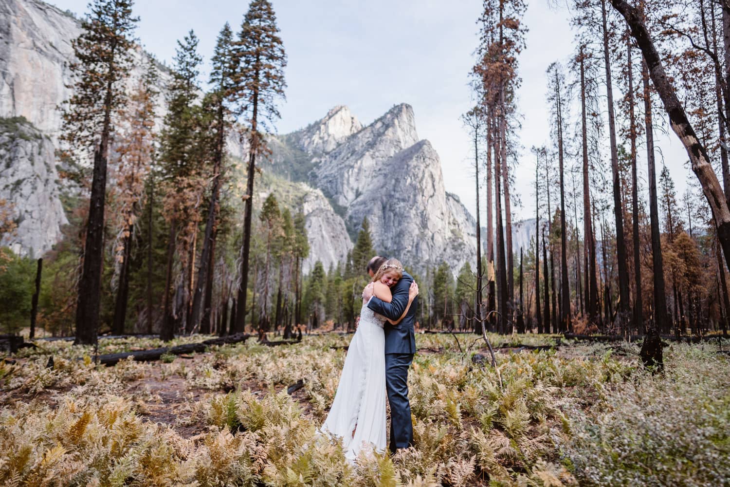 Couple sharing a hug in a field in the fall at their Yosemite elopement.
