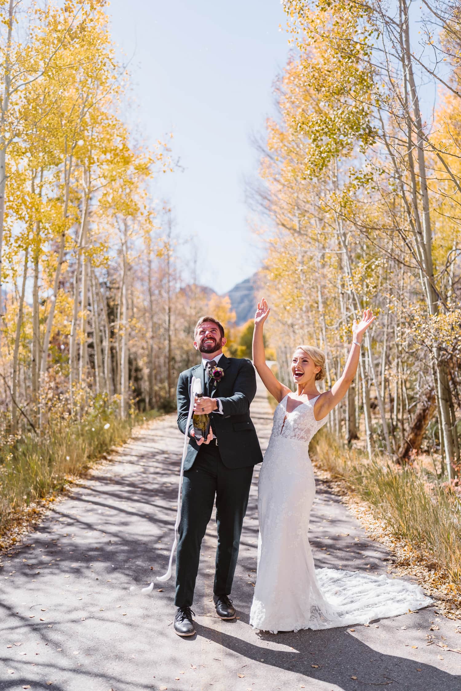 Couple spraying champagne for their Breckenridge, Colorado elopement.