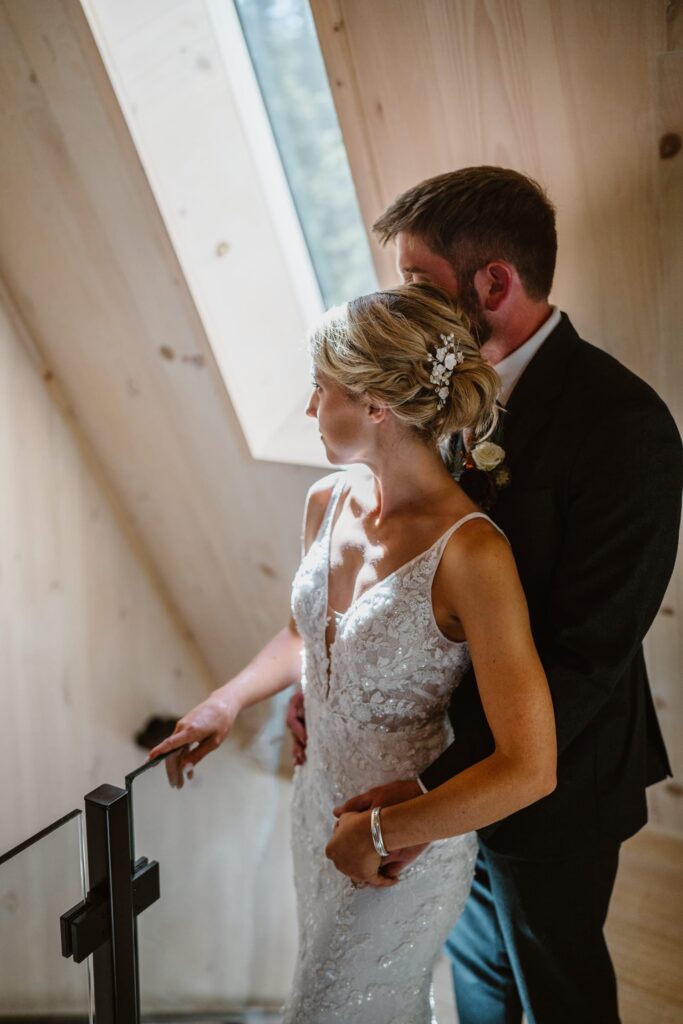 Couple sharing a moment near a skylight in their airbnb during their Colorado elopement.