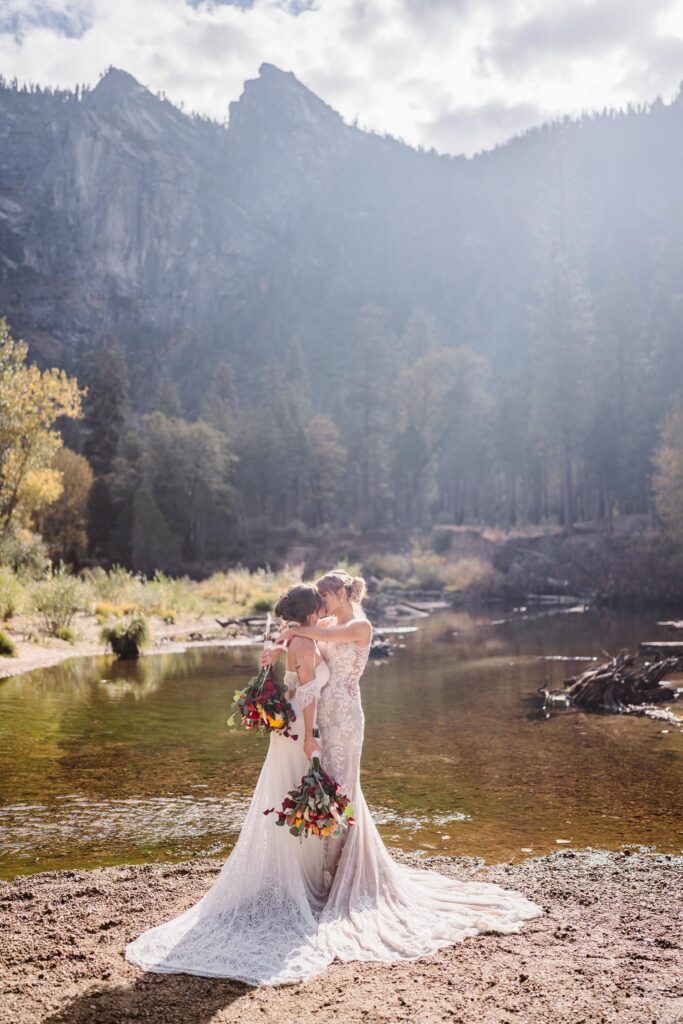 Couple standing near the Merced River at their Yosemite elopement.