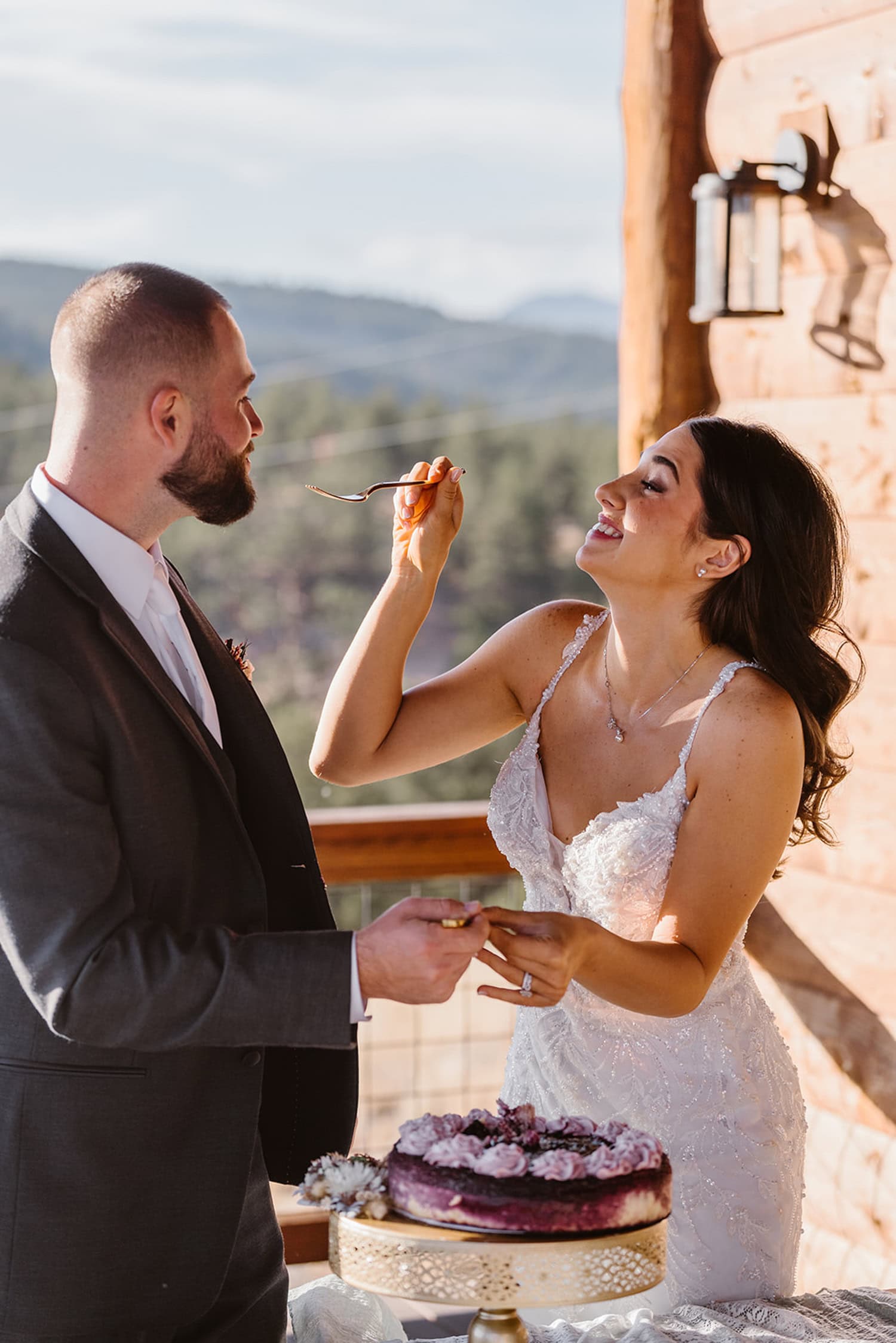 Couple sharing cake at their Airbnb elopement.