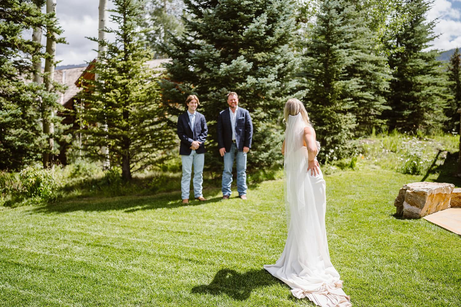 Bride having a first look with her dad and brother at her Airbnb elopement.